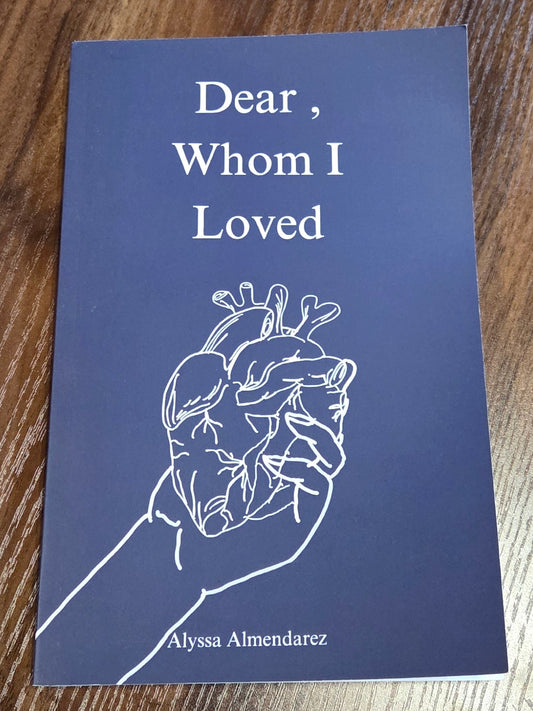 Blue book titled 'Dear Whom I Loved' on a wooden surface